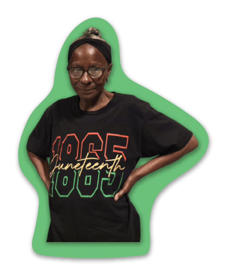Catherine Gainey, hands on her hips, in a Juneteenth T-shirt.